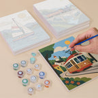 Painting one of the Scenic Rides designs next to a stack of mini canvases