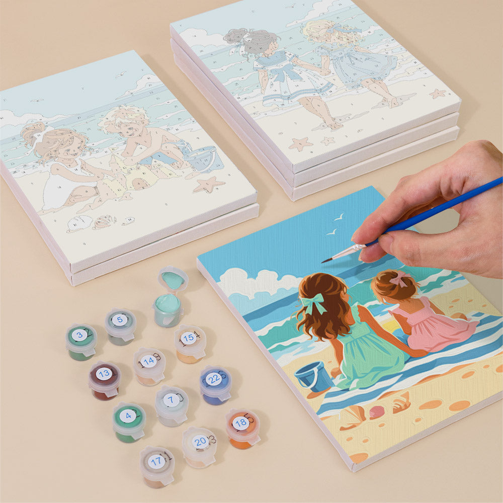 Painting one of the Seaside Friends designs next to a stack of mini canvases