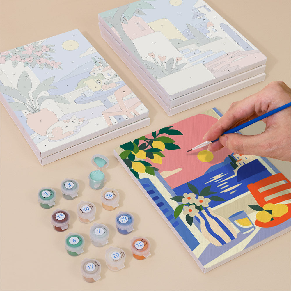 Painting one of the Seaside Terraces designs next to a stack of mini canvases