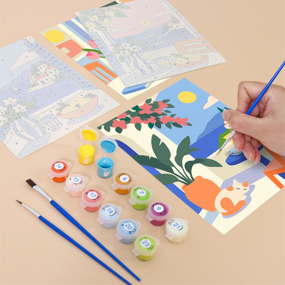 Filling in a Seaside Terraces mini canvas with numbered acrylic paints and a fine brush