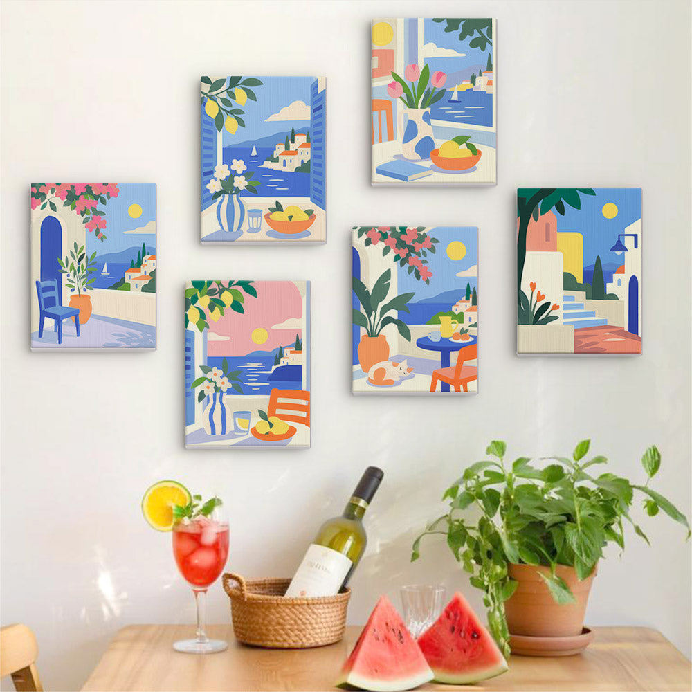 Six finished Seaside Terraces mini paintings hung on a wall above a table