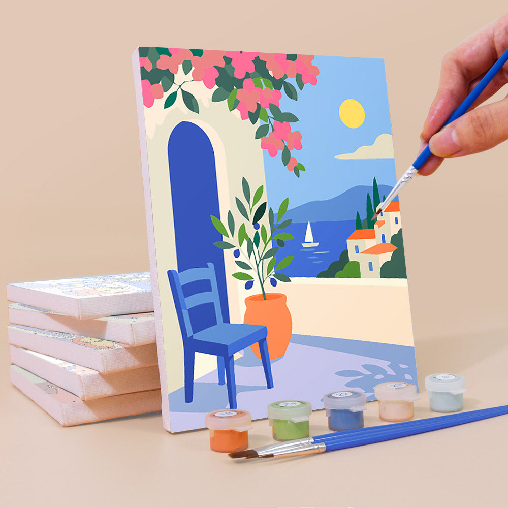 Painting a Seaside Terraces mini canvas propped up beside numbered acrylic paints