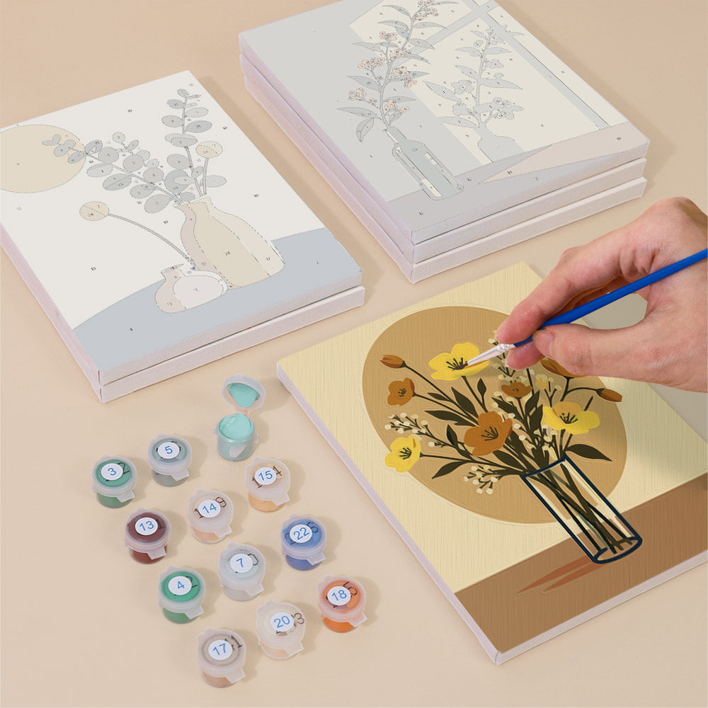 Painting one of the Shadow and Stems designs next to a stack of mini canvases