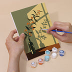 Hand holding a Shadow and Stems mini canvas while painting the details