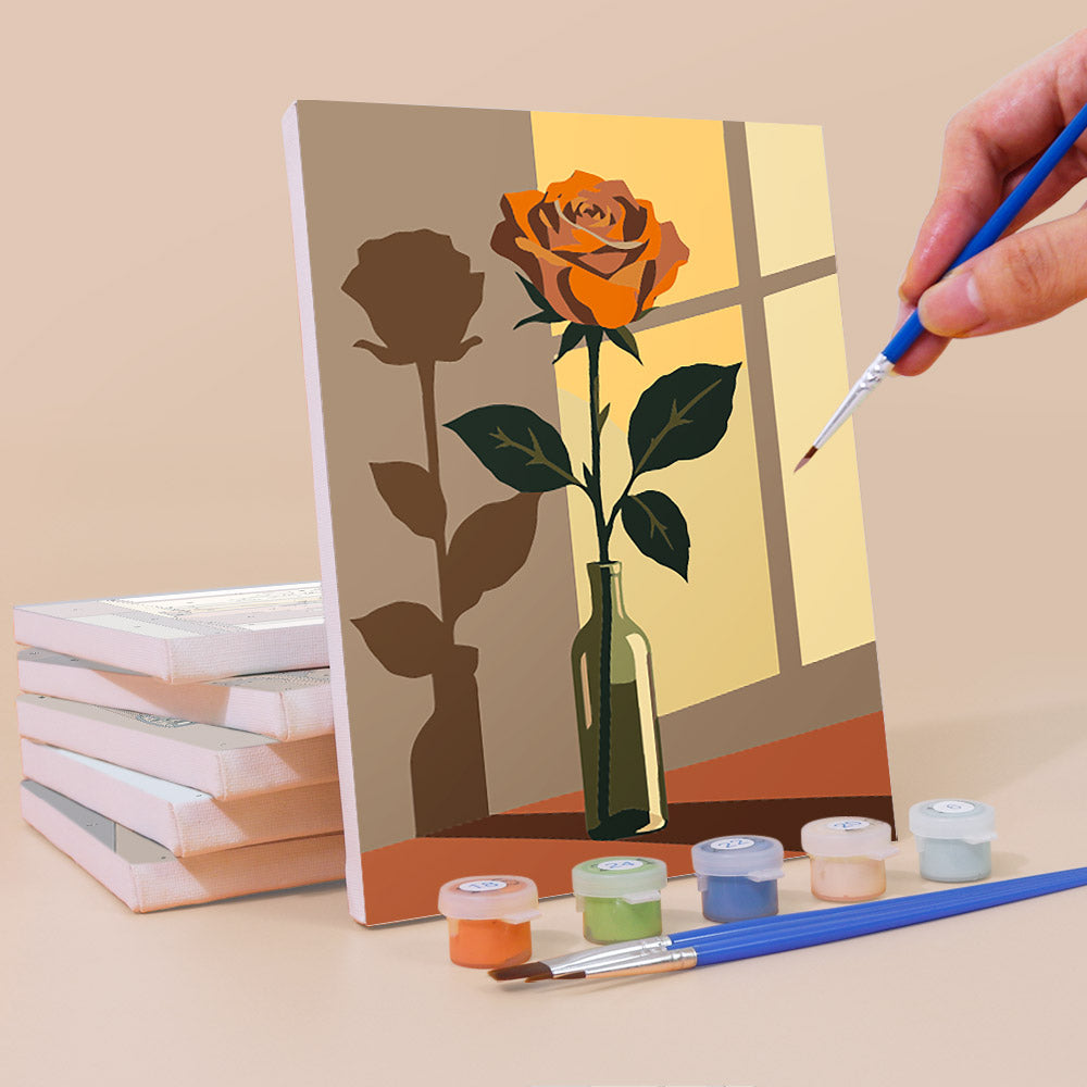 Painting a Shadow and Stems mini canvas propped up beside numbered acrylic paints