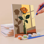 Painting a Shadow and Stems mini canvas propped up beside numbered acrylic paints