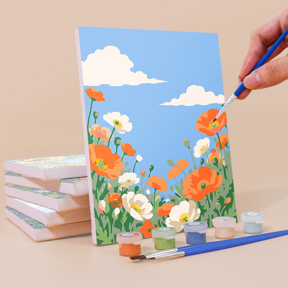 Painting a Sky Garden mini canvas propped up beside numbered acrylic paints