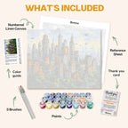 What's included in the Skyline of Tomorrow paint by numbers kit: numbered linen canvas, reference sheet, color guide, 24 acrylic paints, 3 brushes and thank you card