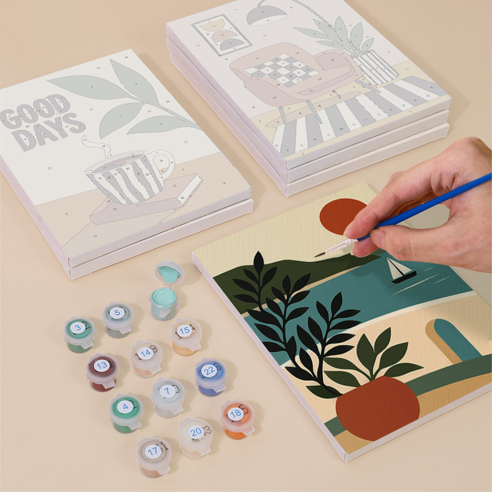 Painting one of the Slow Life designs next to a stack of mini canvases