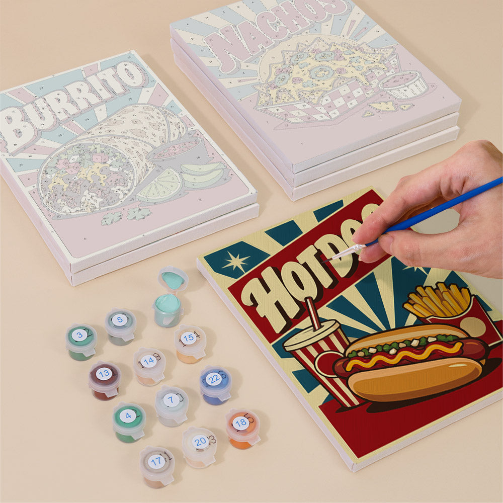 Painting one of the Snack Bar Classics designs next to a stack of mini canvases
