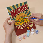 Hand holding a Snack Bar Classics mini canvas while painting the details