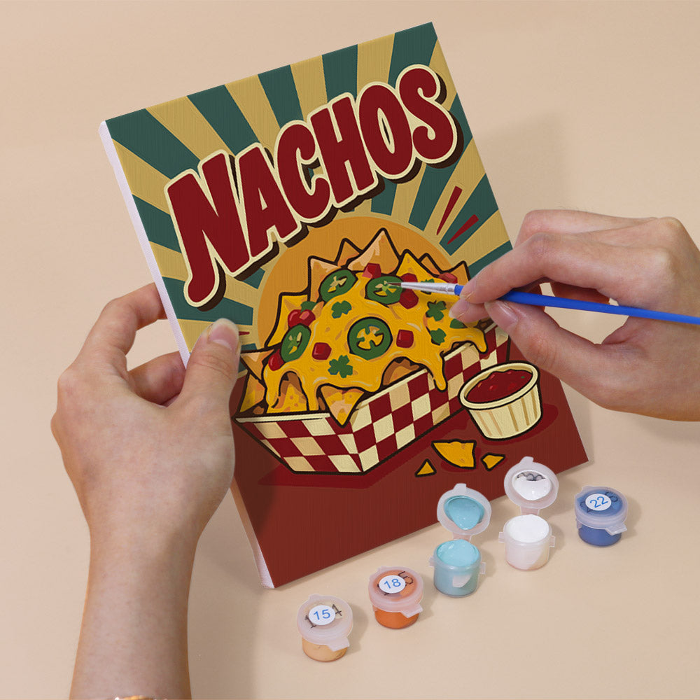 Hand holding a Snack Bar Classics mini canvas while painting the details