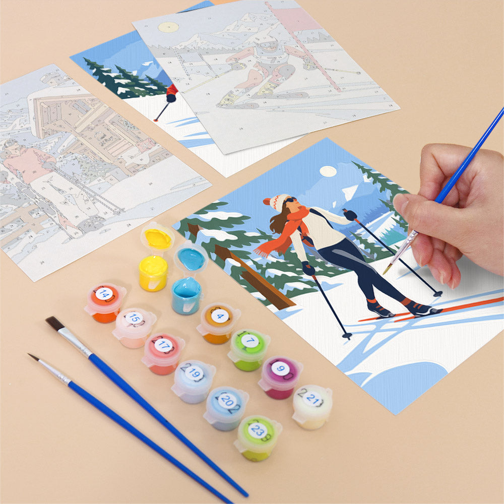 Filling in a Snow Day Skiers mini canvas with numbered acrylic paints and a fine brush