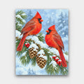 Snowy Pine Cardinals paint by numbers kit of two red cardinals on a snow-covered pine branch with pine cones and red berries