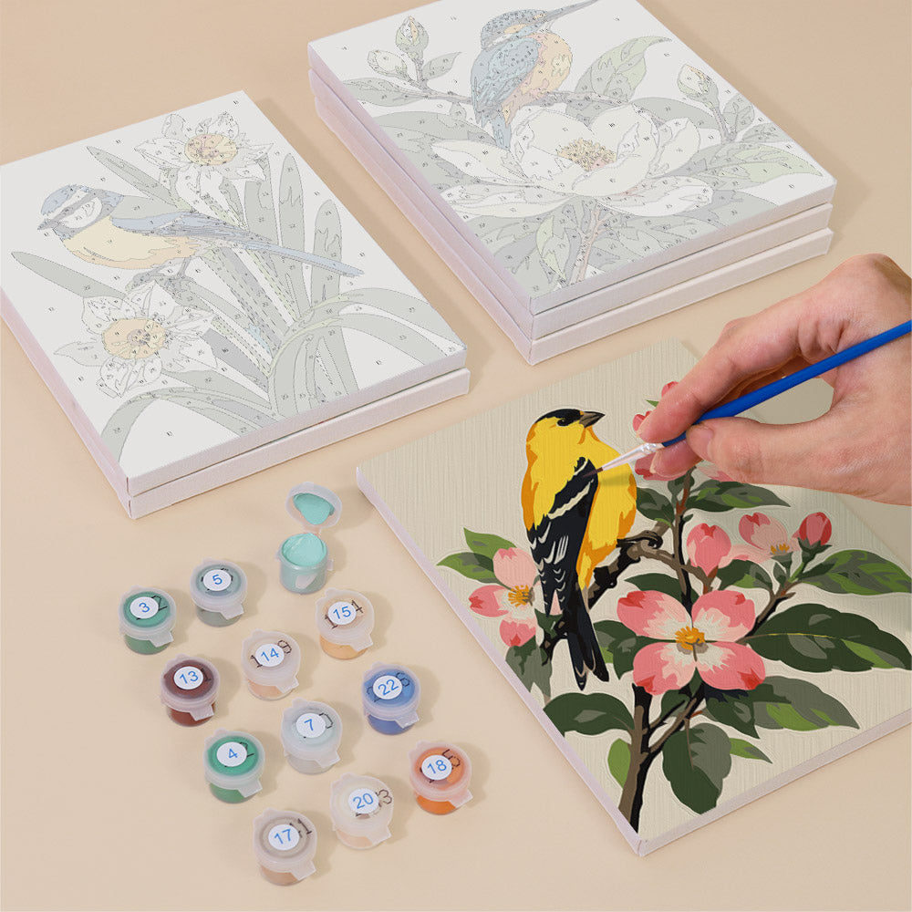 Painting one of the Songbird Blooms designs next to a stack of mini canvases