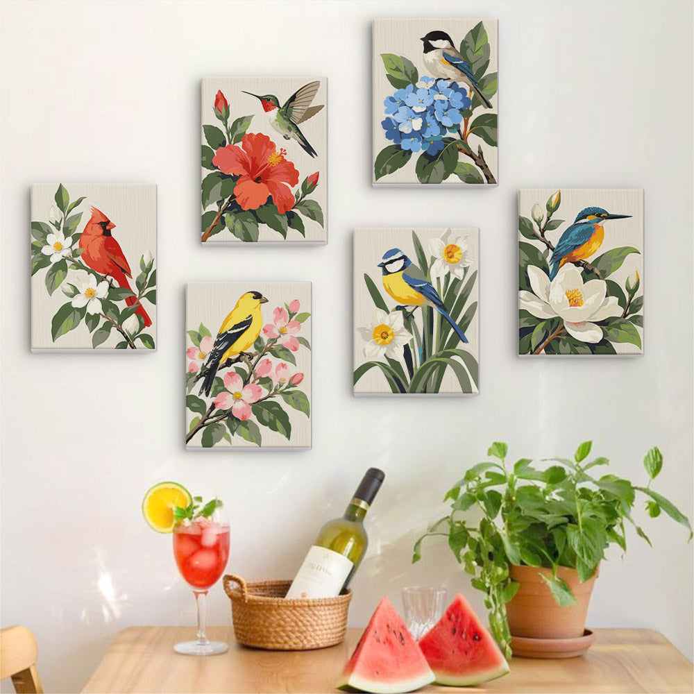 Six finished Songbird Blooms mini paintings hung on a wall above a table