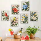 Six finished Songbird Blooms mini paintings hung on a wall above a table