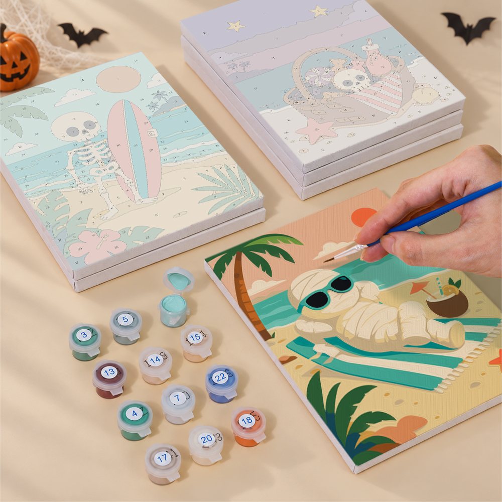 Painting one of the Spooky Beach Party designs next to a stack of mini canvases