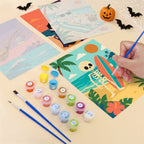 Filling in a Spooky Beach Party mini canvas with numbered acrylic paints and a fine brush