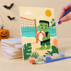 Painting a Spooky Beach Party mini canvas propped up beside numbered acrylic paints