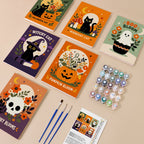 Painting one of the Spooky Blooms designs next to a stack of mini canvases