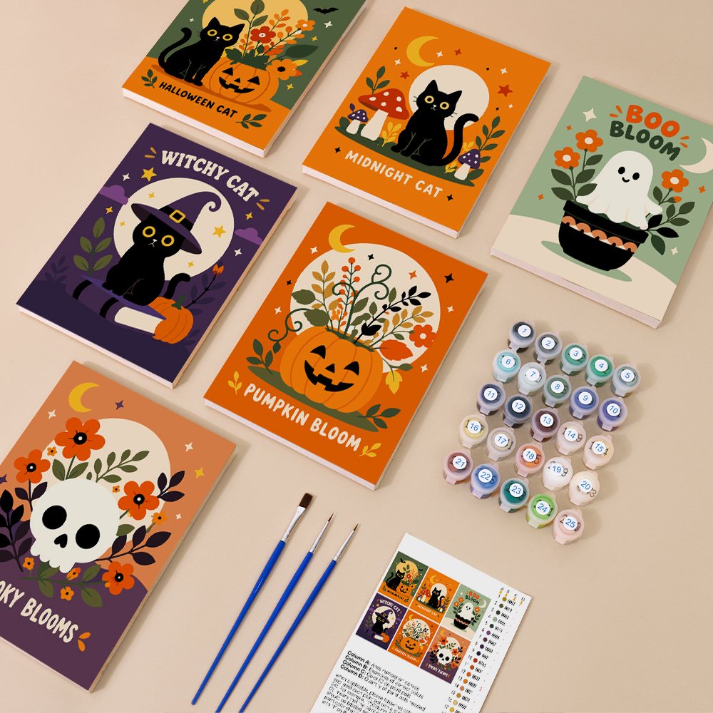 Painting one of the Spooky Blooms designs next to a stack of mini canvases