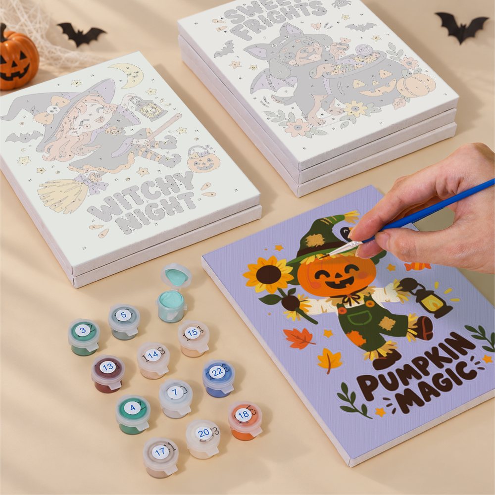 Painting one of the Spooky Cutie Sayings designs next to a stack of mini canvases