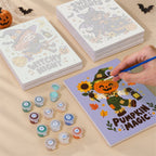 Painting one of the Spooky Cutie Sayings designs next to a stack of mini canvases