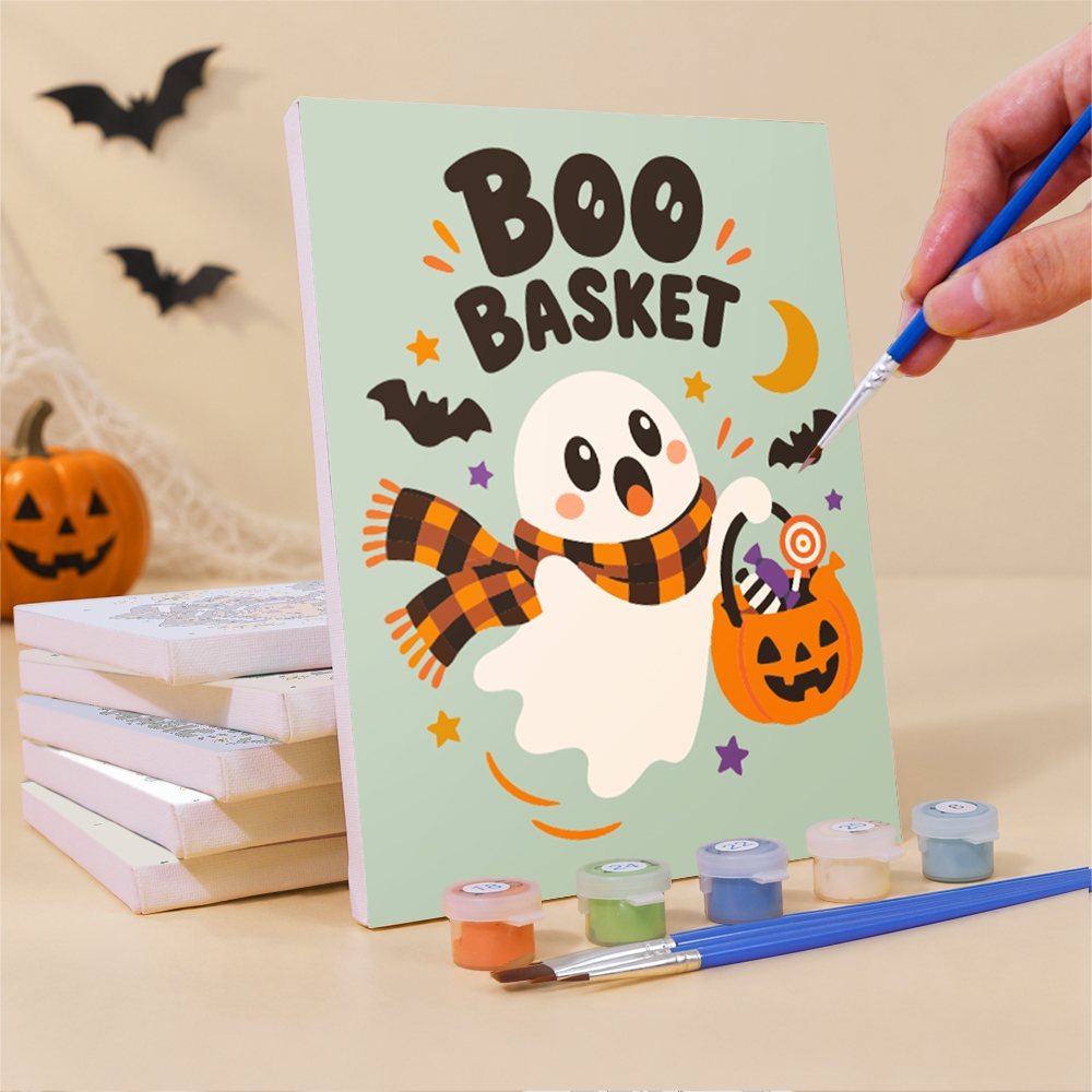 Painting a Spooky Cutie Sayings mini canvas propped up beside numbered acrylic paints