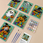 Painting one of the Spooky Season Slogans designs next to a stack of mini canvases