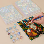 Painting one of the Stained Glass Wildlife designs next to a stack of mini canvases