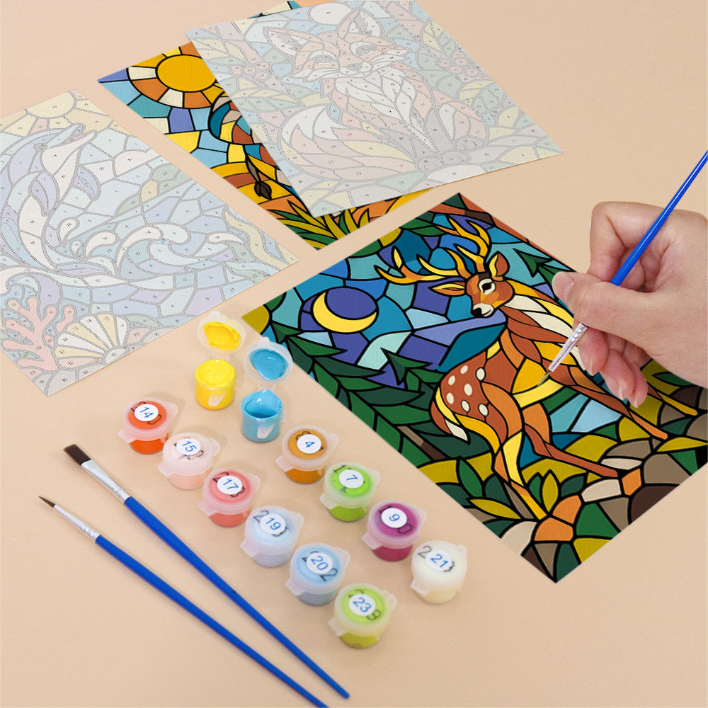 Filling in a Stained Glass Wildlife mini canvas with numbered acrylic paints and a fine brush
