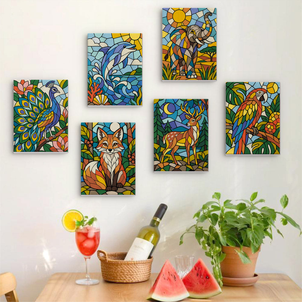 Six finished Stained Glass Wildlife mini paintings hung on a wall above a table