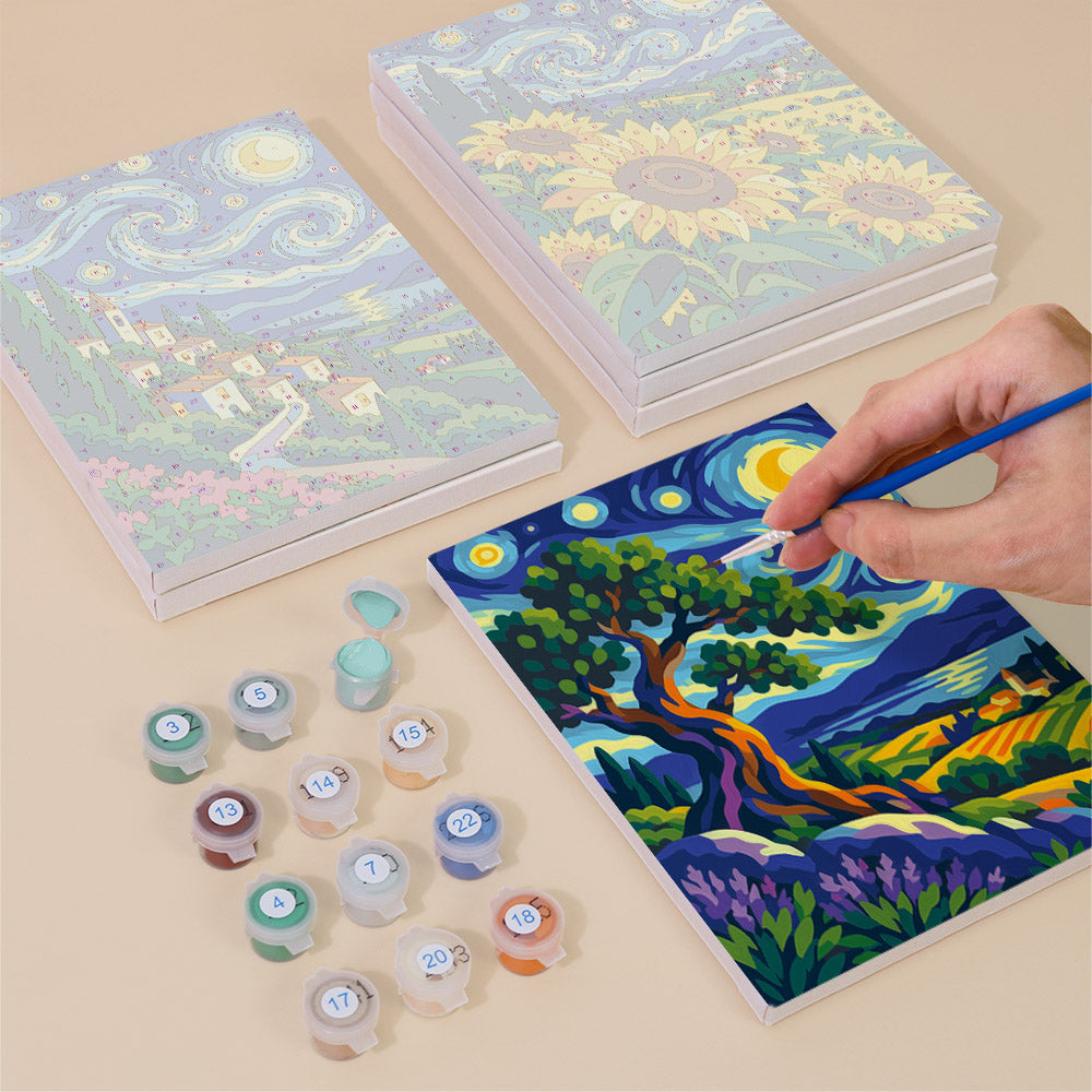 Painting one of the Starry Swirls designs next to a stack of mini canvases