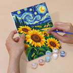 Hand holding a Starry Swirls mini canvas while painting the details