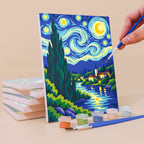 Painting a Starry Swirls mini canvas propped up beside numbered acrylic paints