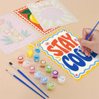 Filling in a Stay Cool Summer mini canvas with numbered acrylic paints and a fine brush