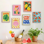 Six finished Stay Cool Summer mini paintings hung on a wall above a table
