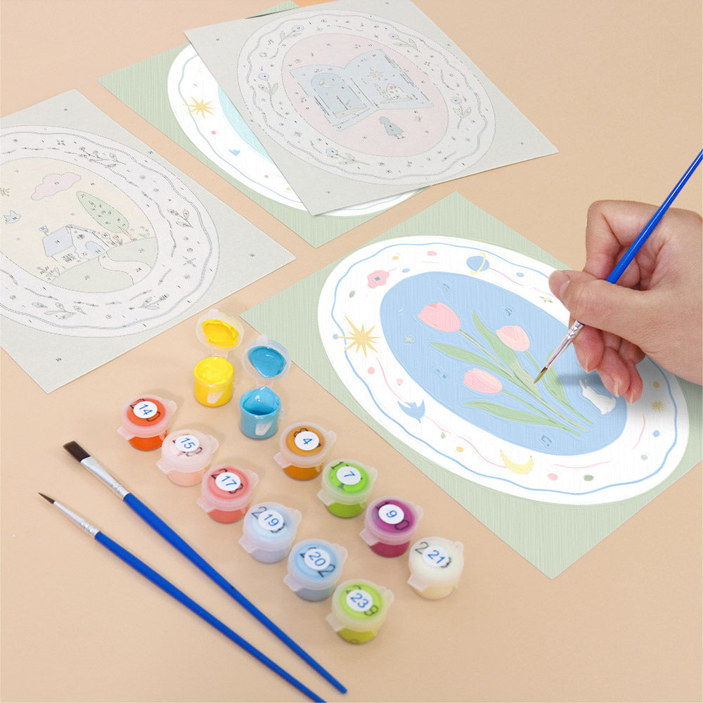 Filling in a Storybook Cameos mini canvas with numbered acrylic paints and a fine brush