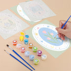 Filling in a Storybook Cameos mini canvas with numbered acrylic paints and a fine brush