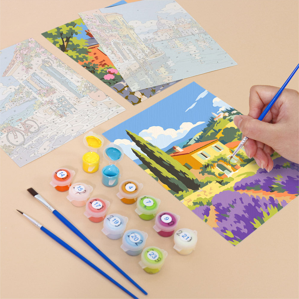 Filling in a Storybook Villages mini canvas with numbered acrylic paints and a fine brush