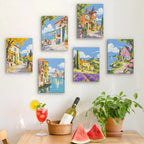 Six finished Storybook Villages mini paintings hung on a wall above a table