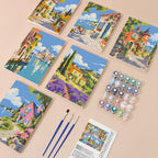 Storybook Villages mini paint by numbers kit with six numbered canvases, acrylic paints, brushes and layout