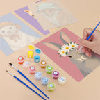Filling in a Style Critters mini canvas with numbered acrylic paints and a fine brush