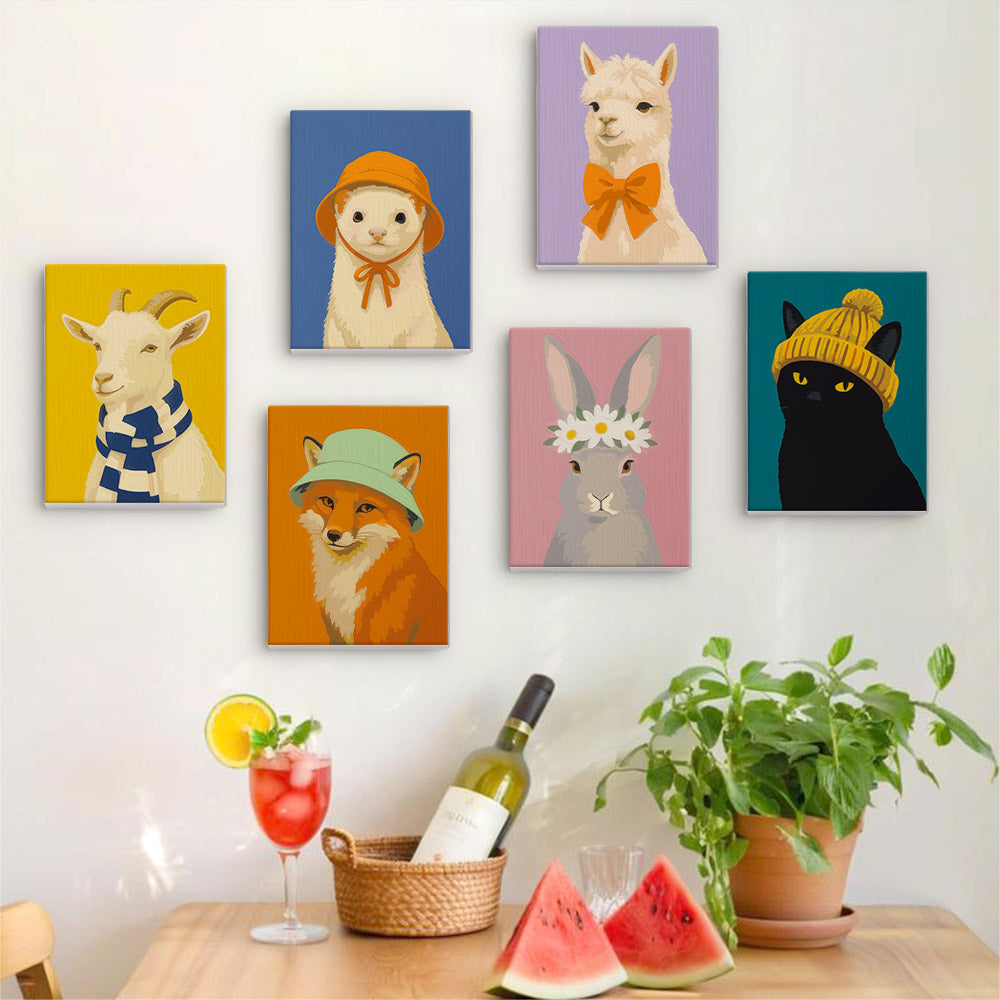 Six finished Style Critters mini paintings hung on a wall above a table