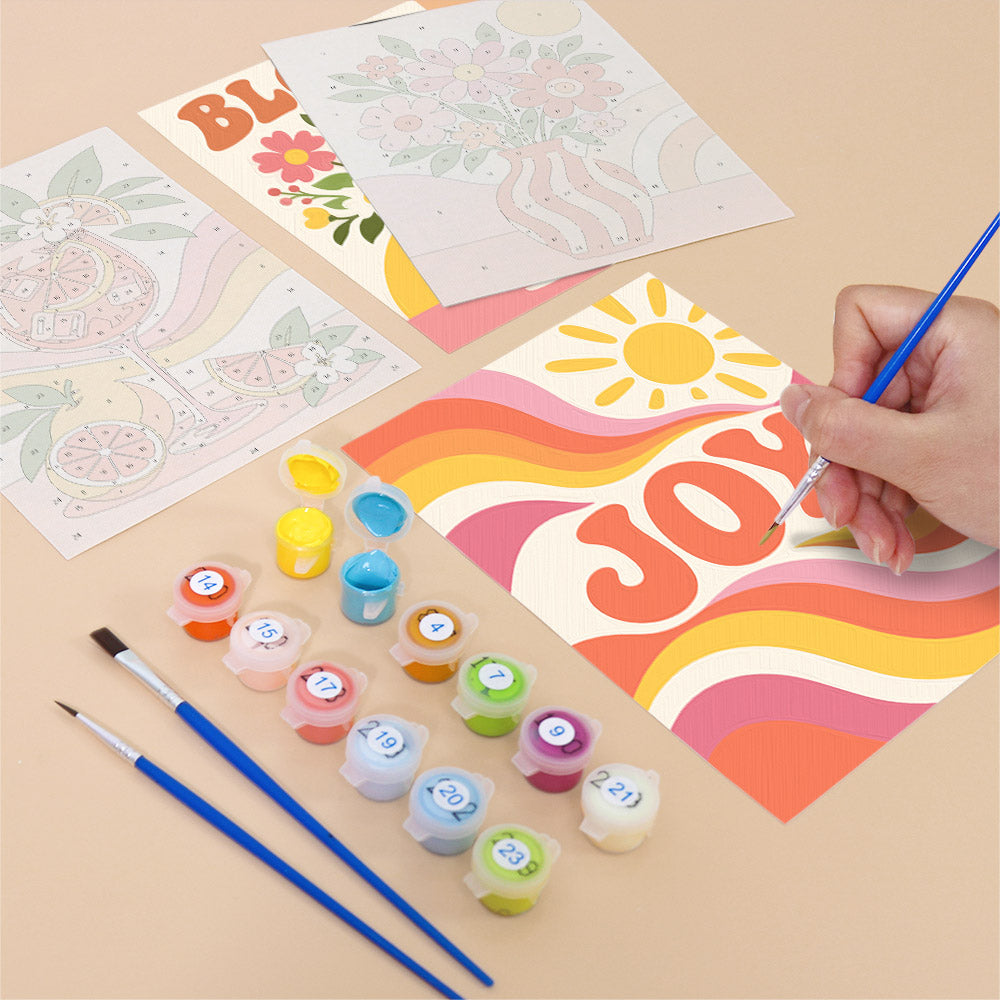 Filling in a Summer Glow mini canvas with numbered acrylic paints and a fine brush