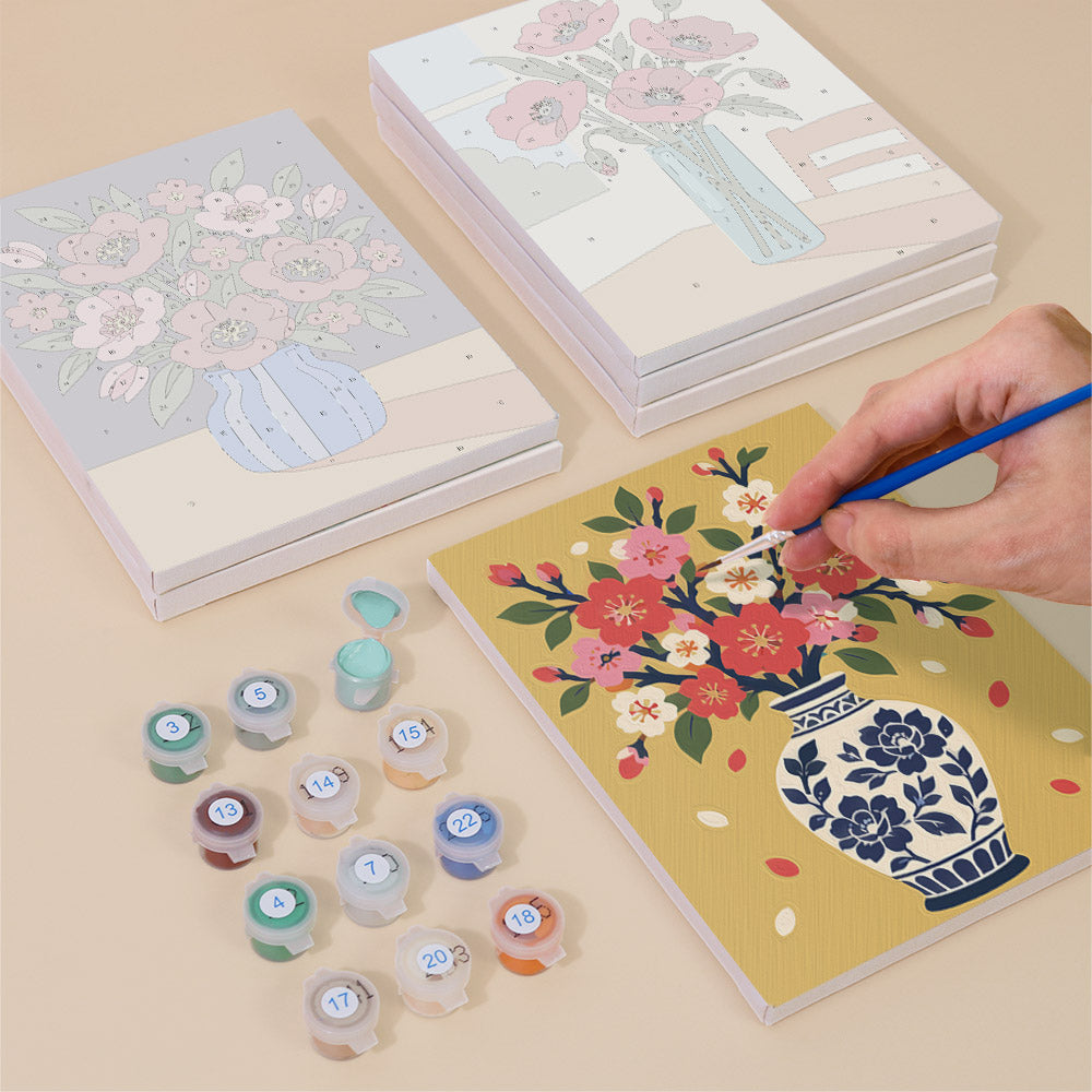 Painting one of the Sunlit Bouquets designs next to a stack of mini canvases
