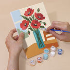Hand holding a Sunlit Bouquets mini canvas while painting the details