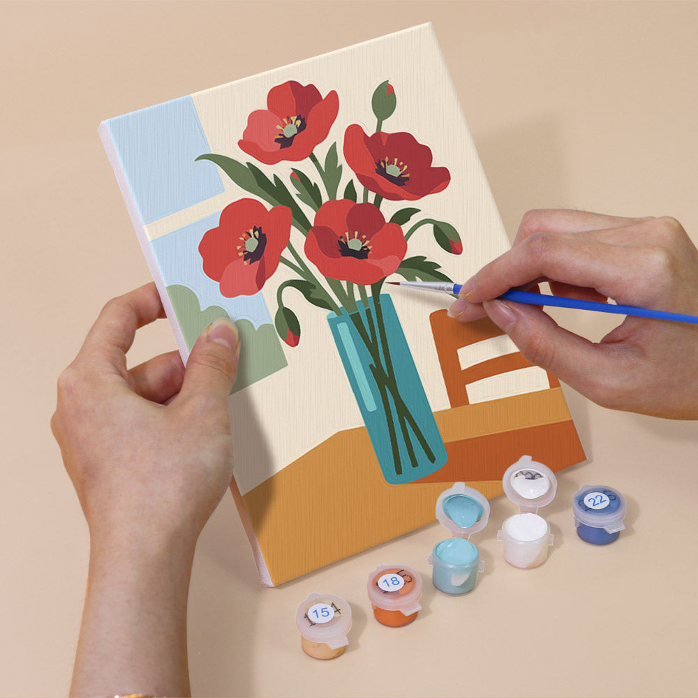 Hand holding a Sunlit Bouquets mini canvas while painting the details