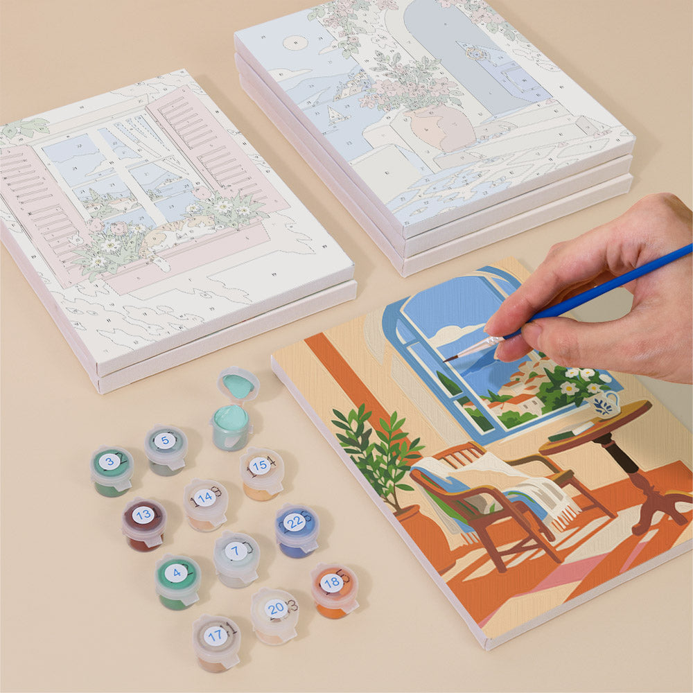 Painting one of the Sunny Doorways designs next to a stack of mini canvases